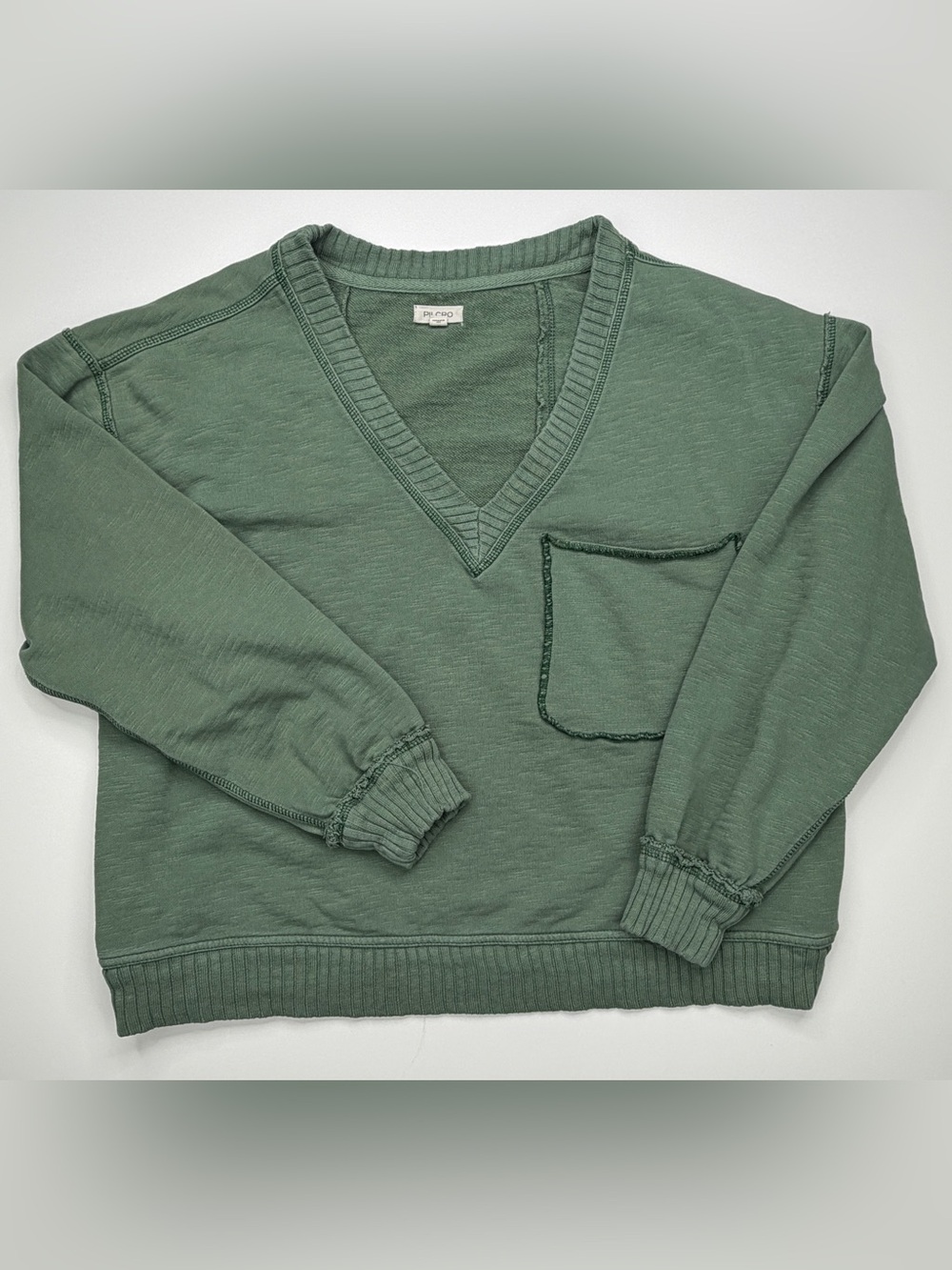 the Pilcro Montana Pocket Knit Top by Anthropologie.